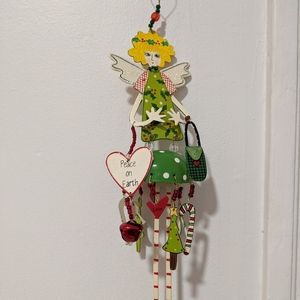 Metal Christmas tree charm girl. Peace on earth.